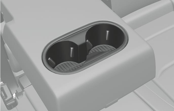 2025 Genesis GV70 rear seat cup holder image. The image displays the dual cup holder integrated into the rear center armrest, featuring two circular slots with internal support tabs. Explains the function of securely holding cups or small beverages for rear passengers.
