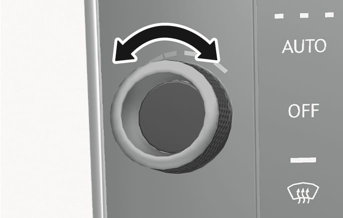 2025 Genesis GV70 temperature control knob image. A circular knob is shown with a black double-headed curved arrow above it, indicating rotation. To the right, 'AUTO', 'OFF' labels and a windshield defrost icon are visible. Explains the function of adjusting the temperature by turning the control knob.