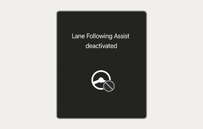 2025 Genesis GV70 Lane Following Assist deactivated warning message image. The instrument cluster displays the text 'Lane Following Assist deactivated' and a white steering wheel icon with a grey prohibition symbol. This explains the function where the system automatically cancels if the driver does not keep their hands on the steering wheel.