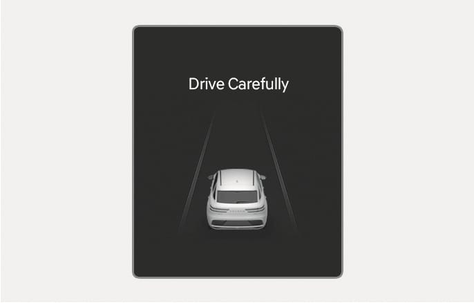 2025 Genesis GV70 instrument cluster warning message image. The text 'Drive Carefully' is displayed at the top, with a rear view of a white vehicle positioned between lane markings on a dark background. Explains the warning message displayed when the vehicle stops after an emergency braking event.