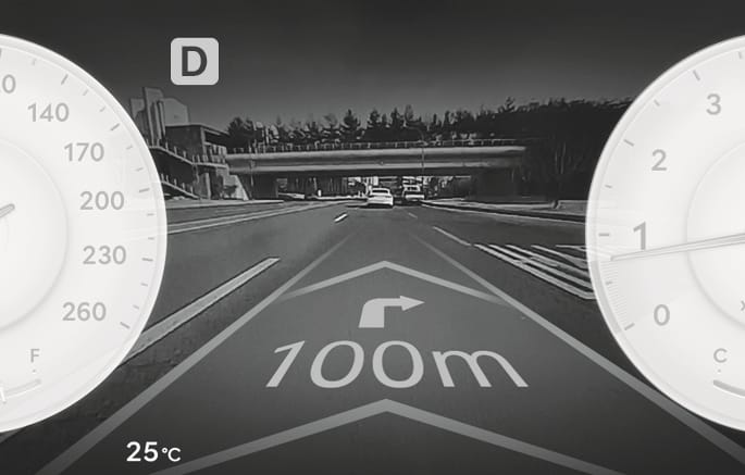 2025 제네시스 GV70 클러스터 AR 모드 화면 이미지입니다. 좌우 속도계와 회전계 사이 중앙 화면에 전방 도로 영상이 배경으로 표시됩니다. 도로 영상 위에는 우회전 화살표와 '100m' 거리 정보가 증강현실 그래픽으로 겹쳐져 있습니다. 홀로그램 증강현실을 이용해 실제 도로 모습 위에 내비게이션 경로 정보를 직관적으로 보여주는 기능을 설명합니다.